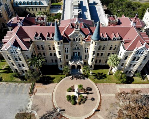 University with metal Victorian Shingles on Roof in red.