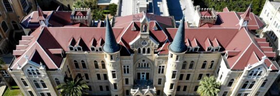 University with metal Victorian Shingles on Roof in red.